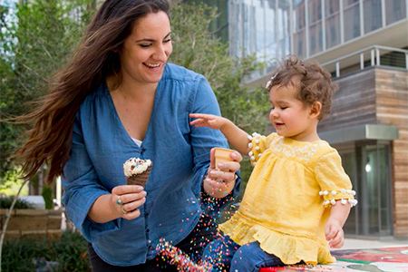 kid eating ice cream with parent